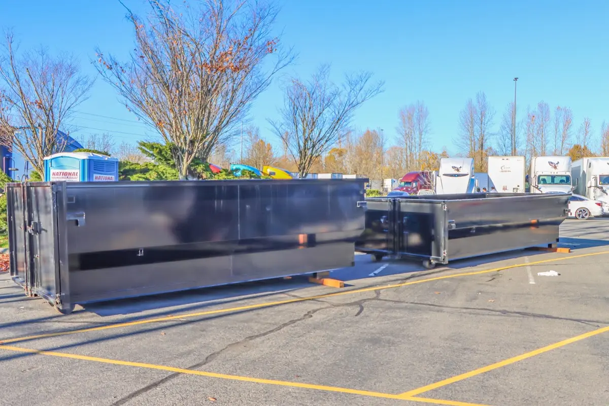 Professional dumpster rental service with roll-off container on residential driveway in Estero